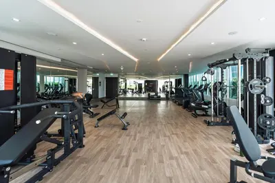 a gym with treadmills and elliptical machines at GuestReady - Spacious 1Bed l Near Butterfly Garden in Dubai