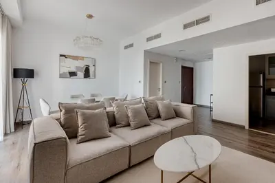 a living room with a couch and a table at 2 bedroom with a full sea view ! BAHAR in Dubai