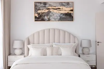 a bedroom with a large white bed with two lamps at 2 bedroom with a full sea view ! BAHAR in Dubai