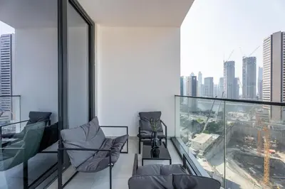 a balcony with chairs and a view of the city at GuestReady - Dubai Skyline & Canal View | 1 BHK in Dubai