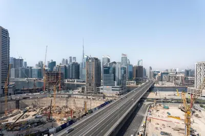 an overhead view of a city with a highway at GuestReady - Dubai Skyline & Canal View | 1 BHK in Dubai