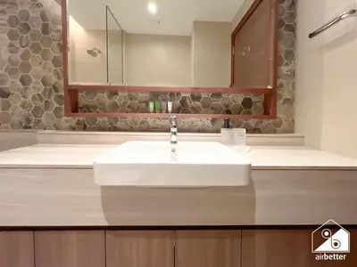 a bathroom with a white sink and a mirror at Luxurious 1BR with Balcony & Premium Stay in Downtown in Dubai