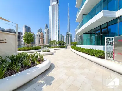 a walkway in front of a building with a city at Luxurious 1BR with Balcony & Premium Stay in Downtown in Dubai