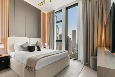 a bedroom with a large bed and a large window at Private Pool Retreat Chic 2BR Sleeps 8 in Dubai