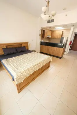 a bedroom with a large bed in a room at Cozy Studio at walking distance from Burj Khalifa and Downtown Dubai in Dubai