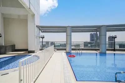 a swimming pool on the roof of a building at Cozy Studio at walking distance from Burj Khalifa and Downtown Dubai in Dubai
