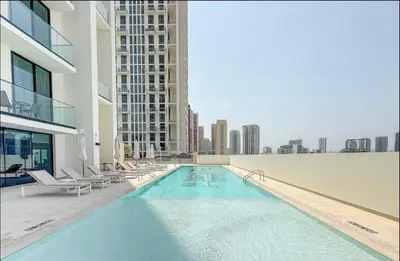 a swimming pool on the roof of a building at High Floor apartment in Jumeirah Village Circle in Dubai