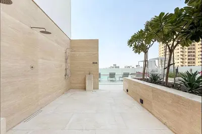 a shower stall in a bathroom with palm trees at High Floor apartment in Jumeirah Village Circle in Dubai