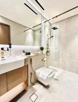 a bathroom with a shower and a toilet and a sink at High Floor apartment in Jumeirah Village Circle in Dubai