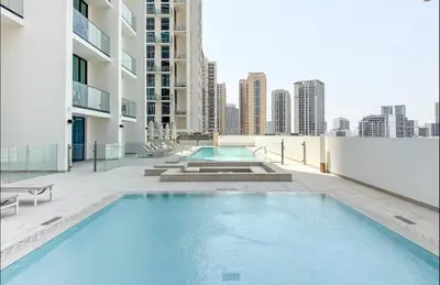 a swimming pool on the roof of a building at High Floor apartment in Jumeirah Village Circle in Dubai