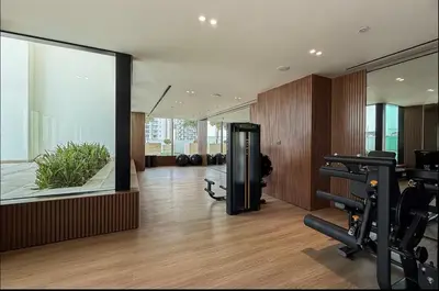 a room with a gym with a large window and exercise equipment at High Floor apartment in Jumeirah Village Circle in Dubai