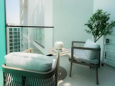 a room with two chairs and a glass table at Stylish High-Floor Studio in Binghatti Azure! in Dubai