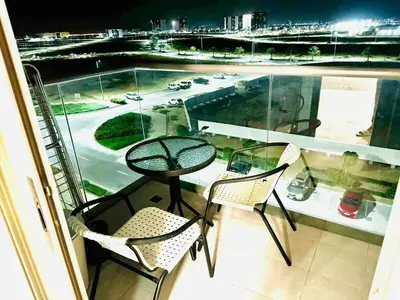 a balcony with a table and chairs and a view of a street at Studio in May 5 Boulevard in Dubai