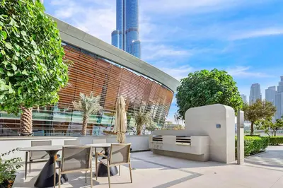 a patio with a table and chairs in front of a building at FIRST CLASS 1BR Burj Khalifa & Skyline Views in Dubai