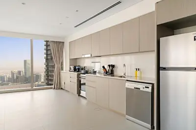 a kitchen with stainless steel appliances and a large window at FIRST CLASS 1BR Burj Khalifa & Skyline Views in Dubai