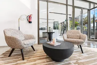 two chairs and a table in a living room at FIRST CLASS 1BR Burj Khalifa & Skyline Views in Dubai