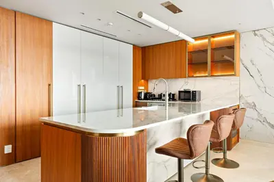 a kitchen with a counter and two stools at FIRST CLASS 4BR Elegant Beach House Retreat in Dubai