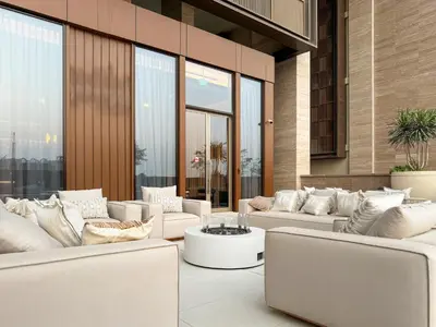 a lobby with white couches and tables and windows at FIRST CLASS 4BR Elegant Beach House Retreat in Dubai