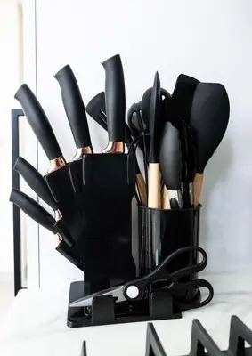 a container of cooking utensils on a counter at Sleeps 4 I Pool I Circle Mall I Epic Pool in Dubai