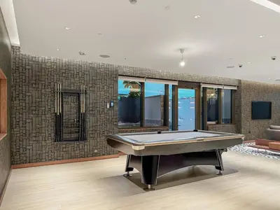 a living room with a pool table in it at FIRST CLASS 3BR Luxury Meets Tranquility in Dubai