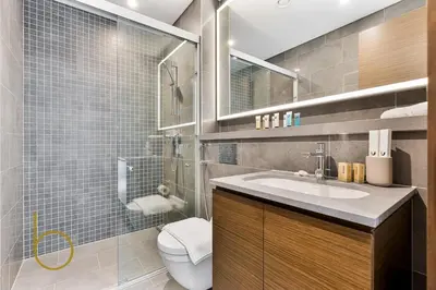 a bathroom with a toilet and a sink and a shower at Bookable 2 Bed Crest Sobha Hartland with Burj view in Dubai