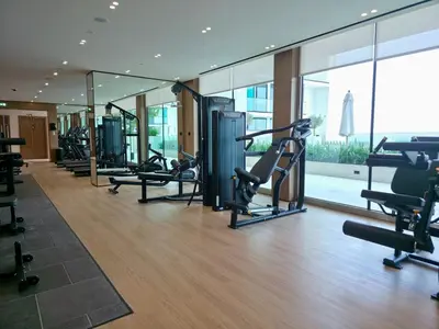 a gym with treadmills and cardio equipment in a building at Royalton - Modern JVC Studio Escape in Dubai