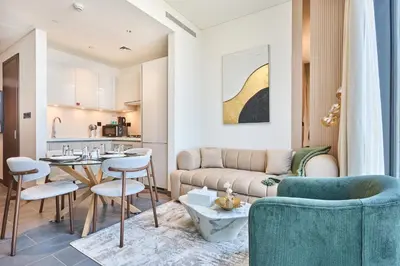 a living room with a couch and a table at STAY BY LATINEM Luxury 1BR Holiday Home CB 3306 Near Burj Khalifa in Dubai