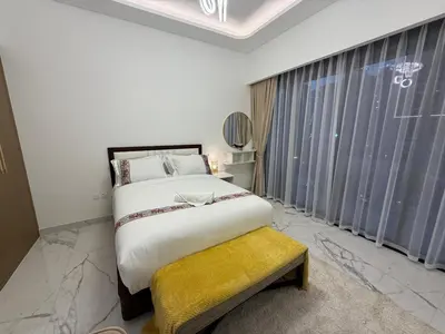 a bedroom with a large bed and a window at Azizi 205 Fully Furnished Apartment in Dubai