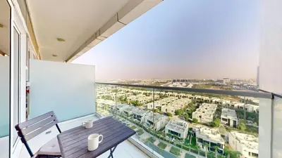 a balcony with a table and a view of a city at Vacationer I Luxury Studio I Scenic Golf Course & Skyline Views I Carson B Tower in Dubai Marina