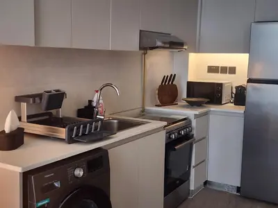 a kitchen with a sink and a stove and a refrigerator at City View Apartment 5 min to Downtown and 5 min to World Trade Center DIFC in Dubai