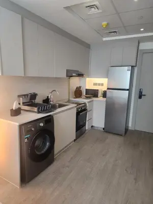 a kitchen with a washing machine and a refrigerator at City View Apartment 5 min to Downtown and 5 min to World Trade Center DIFC in Dubai