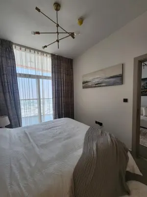 a bedroom with a bed and a large window at City View Apartment 5 min to Downtown and 5 min to World Trade Center DIFC in Dubai