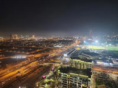 a city lit up at night with traffic at City View Apartment 5 min to Downtown and 5 min to World Trade Center DIFC in Dubai
