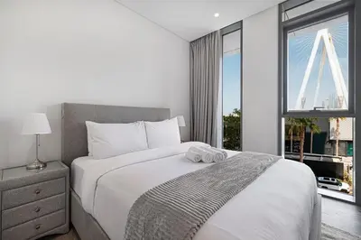 a bedroom with a large bed and a window at Luxury 3 Bedroom Apartment in Bluewaters Residences in Dubai