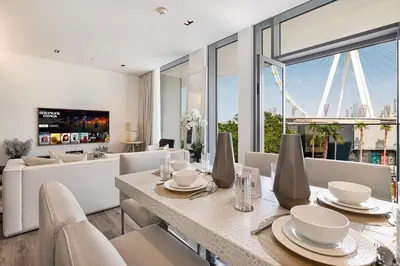 a dining room with a table and chairs and a couch at Luxury 3 Bedroom Apartment in Bluewaters Residences in Dubai