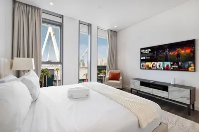 a bedroom with a large white bed and a large window at Luxury 3 Bedroom Apartment in Bluewaters Residences in Dubai