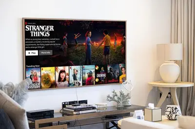 a living room with a movie poster on the wall at Luxury 3 Bedroom Apartment in Bluewaters Residences in Dubai