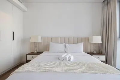 a bedroom with two towels on a bed with two lamps at Luxury 3 Bedroom Apartment in Bluewaters Residences in Dubai