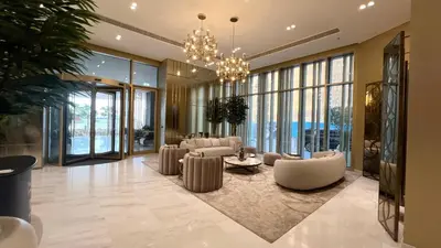 a living room with couches and a chandelier at Elegant 2BR with Sea View & Direct Beach Access in Dubai