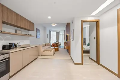 an open kitchen and living room with a couch at Millionaire Residence-Infinity Pool-Business Bay in Dubai