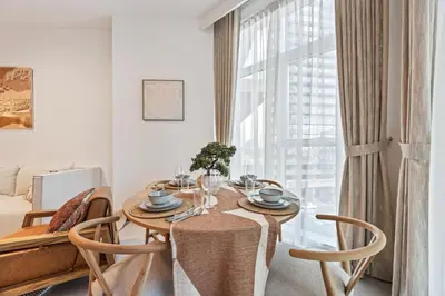 a dining room with a table and chairs and a window at Millionaire Residence-Infinity Pool-Business Bay in Dubai