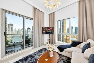 a living room with a couch and a large window at 70m2 Bay Central-Luxury One Bedroom with Spectacular Marina Views in Dubai