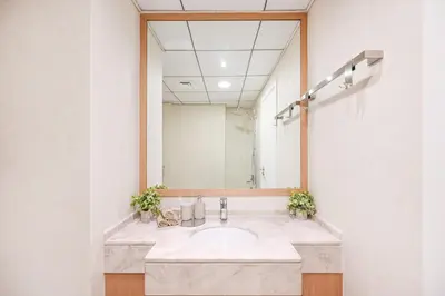 a bathroom with a sink and a large mirror at 70m2 Bay Central-Luxury One Bedroom with Spectacular Marina Views in Dubai