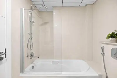 a bathroom with a bath tub with a shower at 70m2 Bay Central-Luxury One Bedroom with Spectacular Marina Views in Dubai