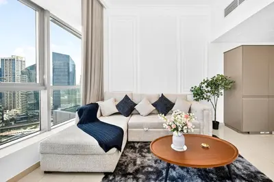 a living room with a couch and a table at 70m2 Bay Central-Luxury One Bedroom with Spectacular Marina Views in Dubai