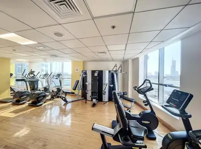 a gym with treadmills and cardio equipment in a building at 70m2 Bay Central-Luxury One Bedroom with Spectacular Marina Views in Dubai