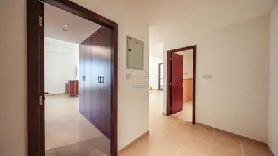 a hallway with two open doors and a hallway with a hallway at Premium 1BR With Stunning Marina & Sea Views in Dubai