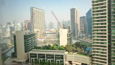 a city skyline with tall buildings and cranes at Premium 1BR With Stunning Marina & Sea Views in Dubai