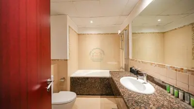 a bathroom with a toilet and a sink and a tub at Premium 1BR With Stunning Marina & Sea Views in Dubai