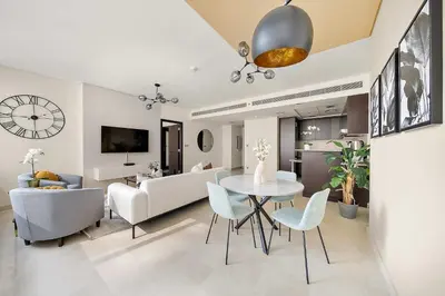 a dining room and living room with a table and chairs at Silkhaus Luxurious 1BR at Sky Gardens in DIFC in Dubai